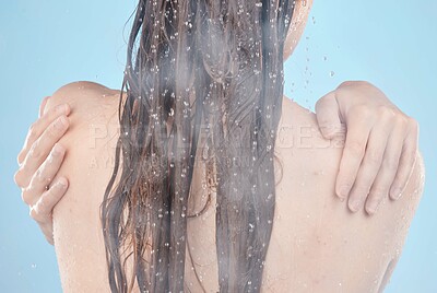 Buy stock photo Woman hands, back and shower in skincare grooming routine, wet hygiene maintenance or healthcare wellness on blue background in studio. Model, water and cleaning in house bathroom or washing hair