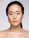 Korean woman, portrait and skincare on studio background for beauty salon, makeup or natural cosmetics. Serious model, face headshot and natural glow from luxury facial, aesthetic wellness and shine 