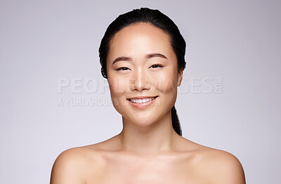 Buy stock photo Skincare, happy beauty and portrait of woman with glow, marketing spa and dermatology on a grey studio background with mockup. Luxury, cosmetics and face of an Asian model smile for advertising skin