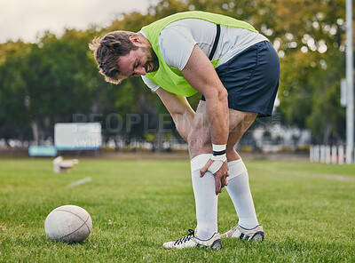 Buy stock photo Rugby, pain and man with legs injury on sports field after practice match, training and game outdoors. Medical emergency, accident and male athlete with joint inflammation, knee sprain and tendinitis