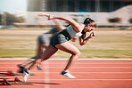 Action, speed and women athlete running sprint in competition for fitness game and training for energy wellness on a track. Sports, stadium and athletic people or runner exercise, speed and workout