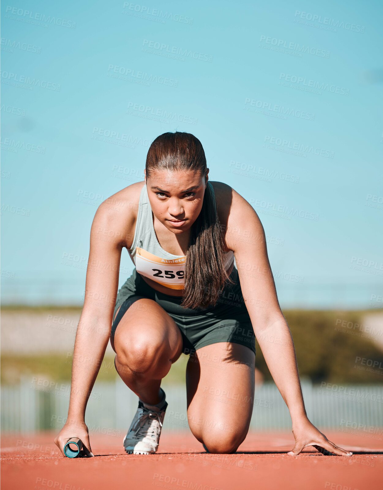 Buy stock photo Start, running and fitness with woman on race track with baton for sports, competition and marathon. Exercise, health and wellness with runner in stadium for challenge, speed and energy performance