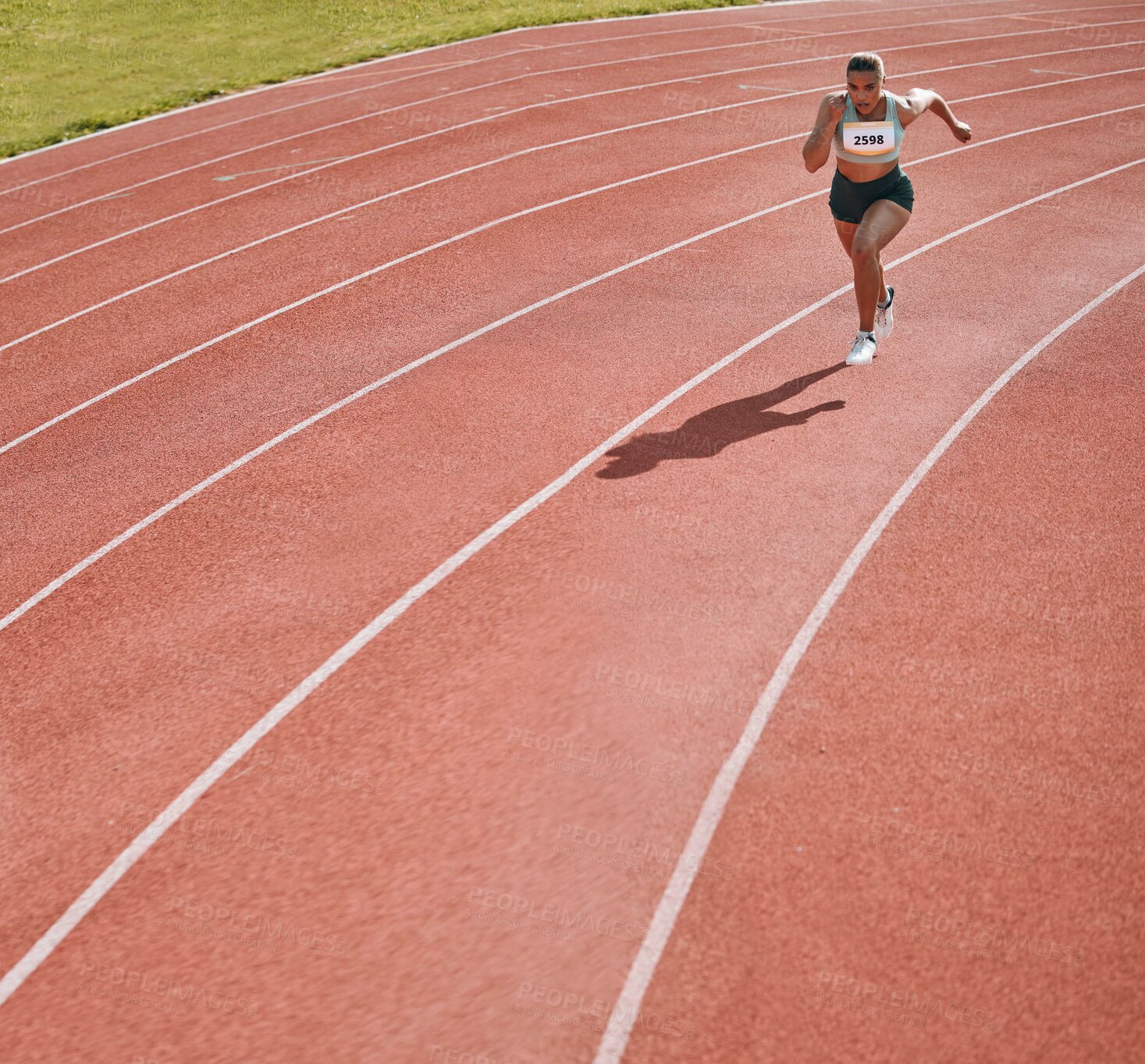 Buy stock photo Woman, athlete and running on stadium in fitness, workout or cardio exercise for practice or training on track. Female person or runner in sport competition, performance or race in outdoor motivation