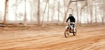 Motorcycle, speed and space with a sports man in the forest for adrenaline while dirt biking. Bike, training and power with a person driving fast on an off road course for freedom or performance