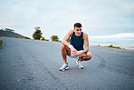 Sports, nature and man athlete breathing on a break of race, marathon or competition training on mountain. Fitness, workout and young male runner resting for an outdoor cardio exercise for endurance.