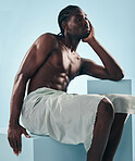 Body, muscle and black man thinking in studio for wellness, grooming or self care on blue background. Topless, chest and African male model relax with cosmetic care, treatment or fine art aesthetic 