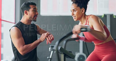 Buy stock photo Fitness, training on an exercise bike and a woman with her coach in the gym to time her speed on a sports watch. Exercise, motivation and a personal trainer with a young athlete for workout support