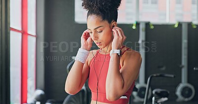 Buy stock photo Woman, gym and earphones for music, thinking and listening for inspiration to workout for wellness. African girl, audio streaming subscription and hearing for exercise, training or fitness with sound