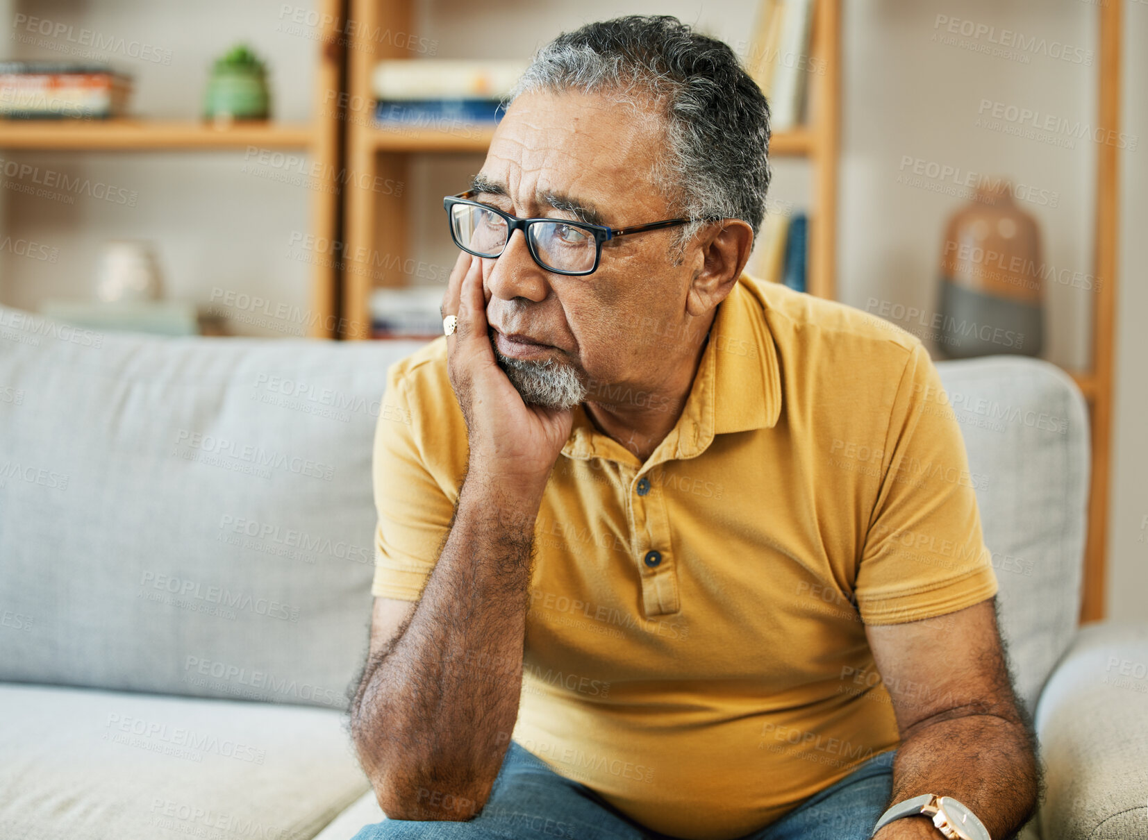 Buy stock photo Face, depression and alzheimer with a sad old man on a sofa in the living room of his retirement home. Mental health, thinking or dementia and a senior person looking lonely with memory nostalgia