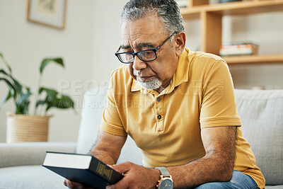 Buy stock photo Man, holding and book in thought at home, memory and alone for comfort in hope. Male, person or grandfather on sofa in living room with thoughts of bible, religion or church in prayer for support