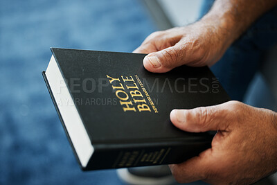 Bible, book and hands of man in home with study of Christian faith, religion or spirituality knowledge. Holy, worship and person with gospel, scripture or learning about God or story of Jesus Christ