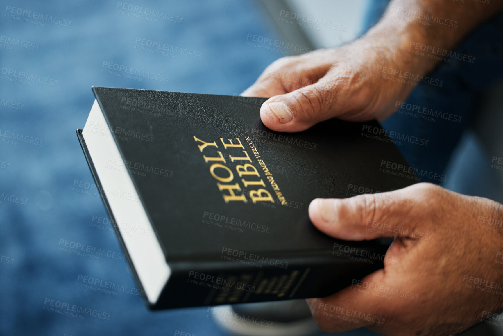 Buy stock photo Bible, book and hands of man in home with study of Christian faith, religion or spirituality knowledge. Holy, worship and person with gospel, scripture or learning about God or story of Jesus Christ