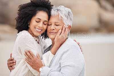 Buy stock photo Women, mother and daughter on beach, hugging and smiling in embrace, love and happiness. Family vacation, joy and bonding for retirement, resting and relaxation on ocean, enjoying and quality time