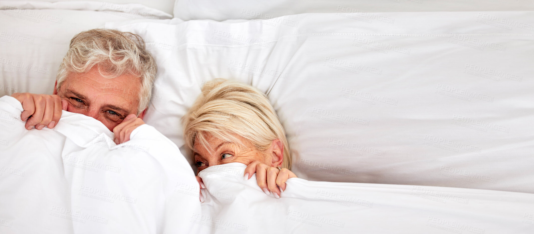 Senior couple, hiding and smile in bed for fun, comfort and bonding for  love, silly and goofy together. Elderly people, marriage and sex in bedroom  in retirement, romance and happiness at home |