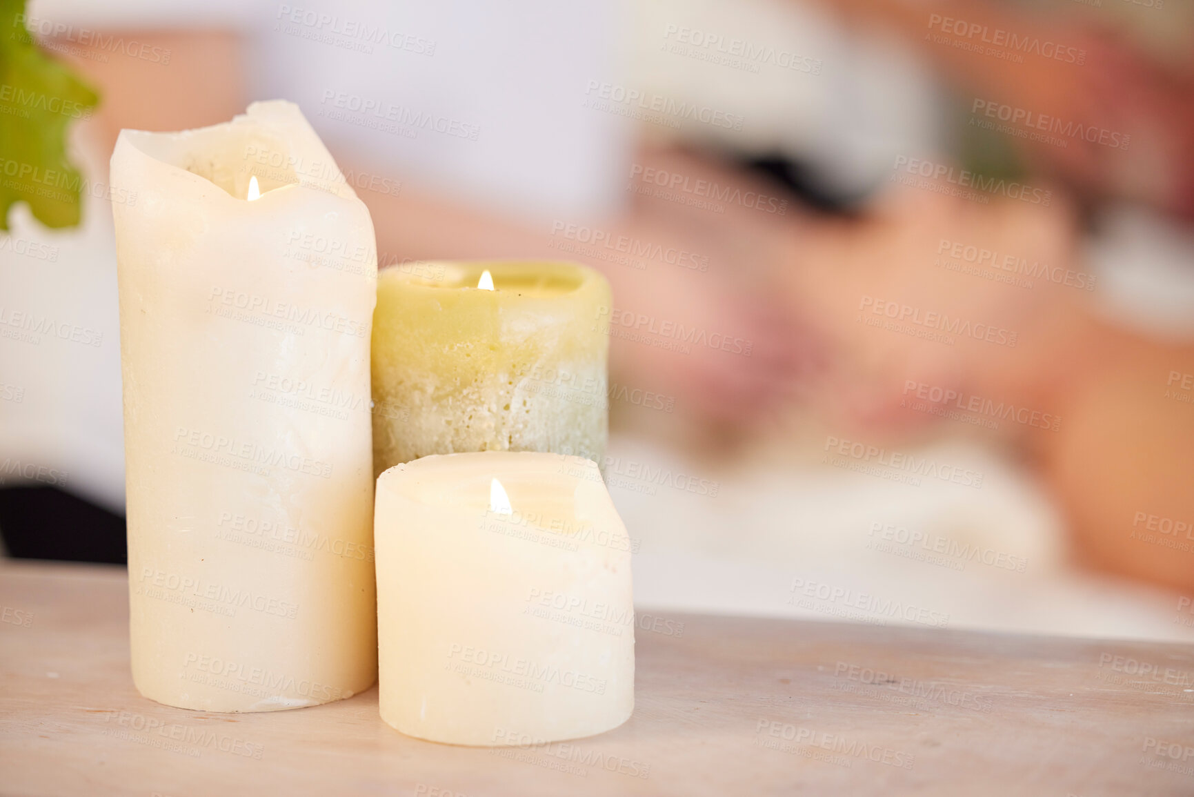 Buy stock photo Zen, table and candles at spa during massage for relax, wellness and lighting at a hotel. Calm, peace and a flame in a room for a luxury treatment, aroma therapy or ambient experience for hospitality