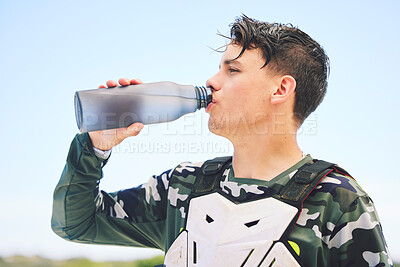 Buy stock photo Man, rider and water for rest after exercise, training or activity on vacation, holiday or travel for competition. Person, racer and break in Namibia for sport, summer and relax with profile in sun