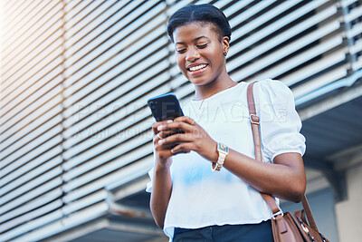 Buy stock photo Cellphone, walking and young woman in the city networking on social media, mobile app or the internet. Happy, technology and African female person scroll on a phone and commuting in urban town street