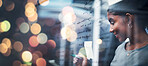 Happy woman, writing and schedule planning at night on glass board for strategy or ideas at office on bokeh background. Female person smile working late on project plan, tasks or agenda at workplace