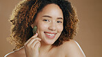 Portrait of happy woman, smile or jade roller in studio with anti aging product or facial tool to relax. Brown background, results or healthy model with cosmetics for wellness or natural skincare