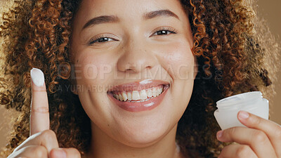 Buy stock photo Skincare, black woman and cream on hand or face for dermatology, beauty or happiness in salon or studio. Skin, care and happy portrait with cosmetics, lotion or product for wellness and confidence