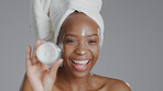 Black woman, face and beauty with skincare, lotion for facial with natural cosmetics on grey background. Portrait, dermatology and African model with cream, moisturizer and treatment in studio