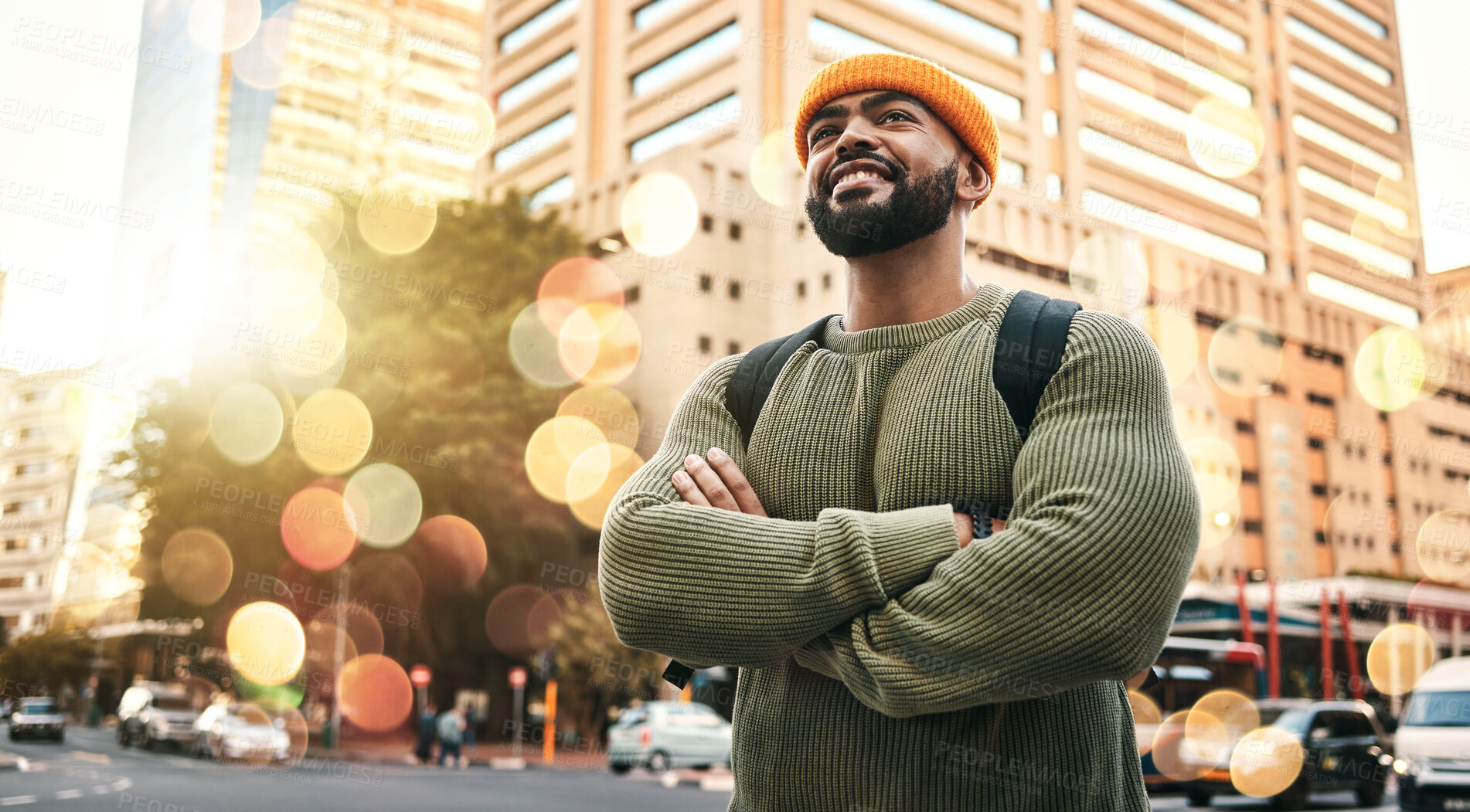 Buy stock photo Happy, man and student with arms crossed in city to travel or commute to university in urban, cbd or town campus. College, person and confident outdoor with smile or relax in street with buildings