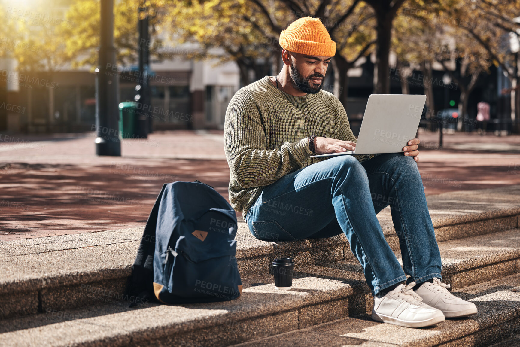 Buy stock photo Student, laptop and outdoor campus for university, college or scholarship research, studying or information on stairs. African man typing on computer for online education, website and e learning FAQ