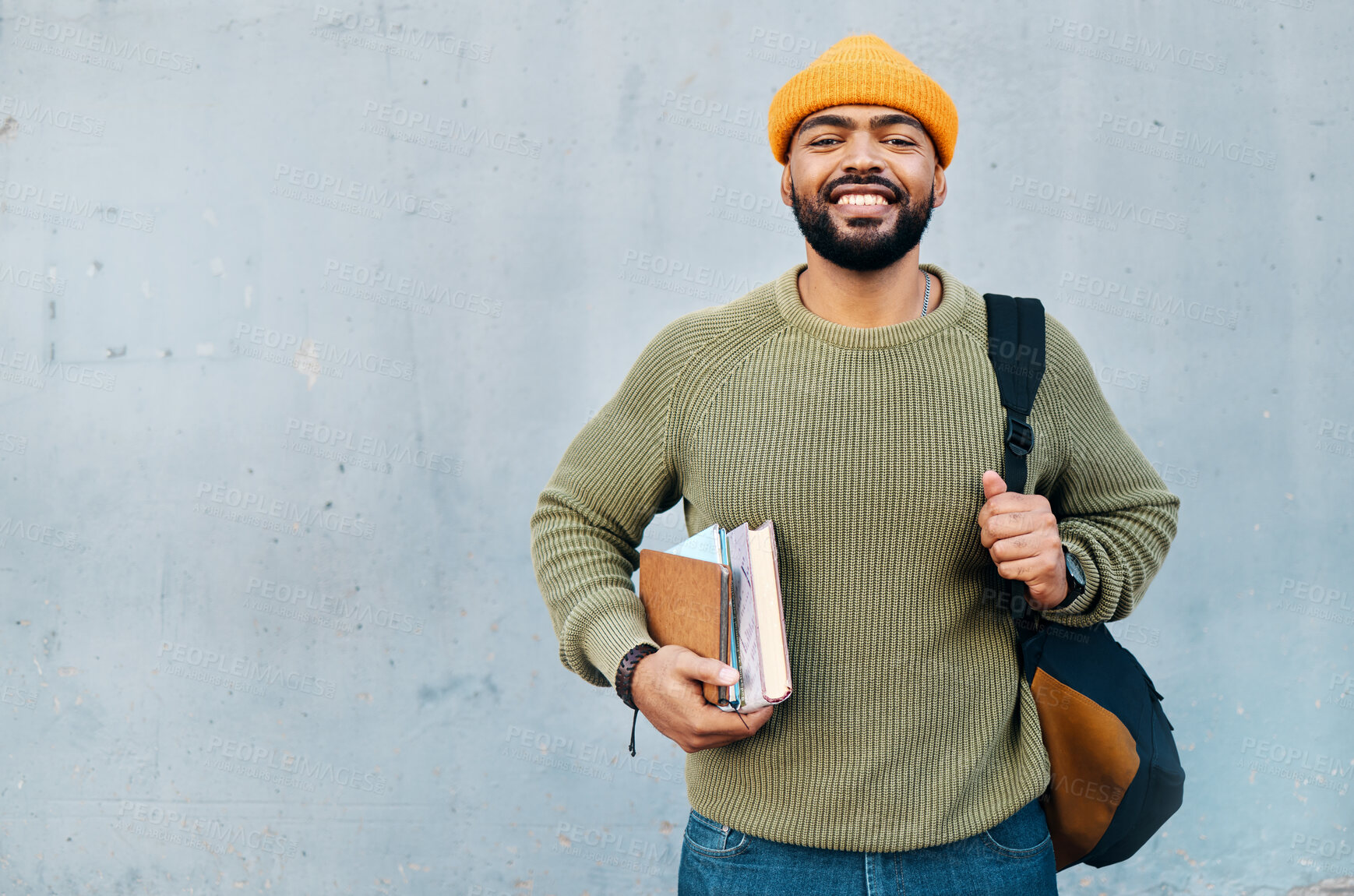 Buy stock photo Student, portrait and backpack for education, learning and smile for university or college on a wall background. Happy young, african man with books, bag and ready for scholarship, study or research