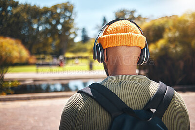 Buy stock photo Back, music headphones and student outdoor, listening to audio or streaming sound online. Radio, podcast and man at park in nature, walking and hearing education media at university campus or college