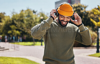 Buy stock photo Music, headphones and happy man at garden outdoor, listening to audio online or hearing sound on internet podcast technology. Smile, streaming radio and person at park for freedom in nature in summer