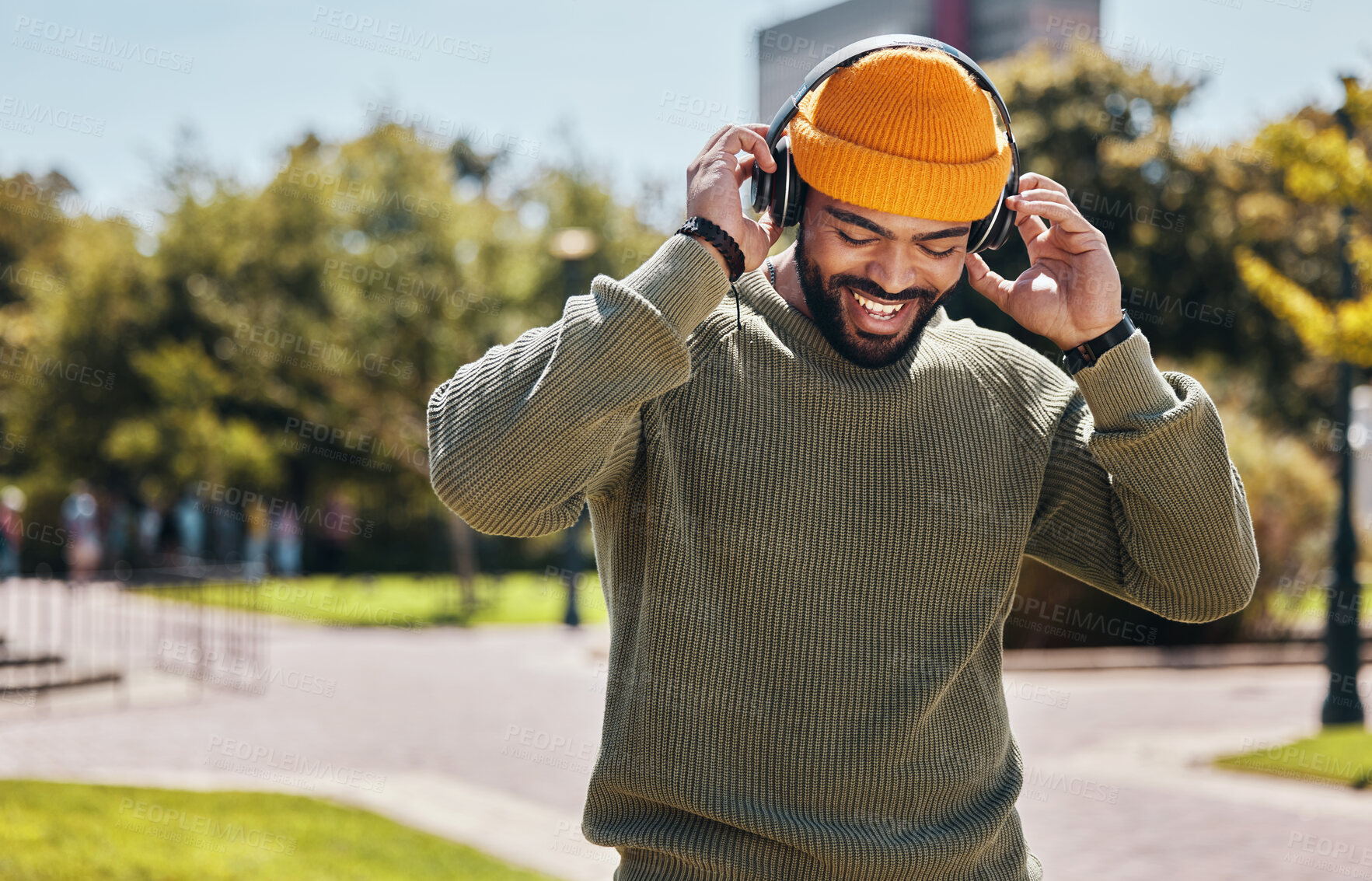 Buy stock photo Music, headphones and happy man at garden outdoor, listening to audio online or hearing sound on internet podcast technology. Smile, streaming radio and person at park for freedom in nature in summer