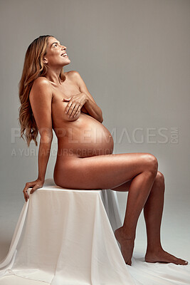 Buy stock photo Nude, beauty and smile with a woman pregnant in studio on a gray background as a mother or parent. Aesthetic, body and wellness with the stomach or belly of a happy young person for pregnancy growth