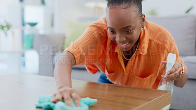 Buy stock photo Black woman, spray bottle and cleaning table for housekeeping, hygiene or domestic service at home. Happy African female person, maid or cleaner smile wiping furniture for bacteria or germ removal