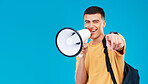 Megaphone, mockup and portrait of man in studio pointing for announcement, speech or rally. Smile, protest and male student from Canada with bullhorn for communication isolated by blue background.