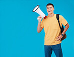 Portrait, megaphone and man with a smile, announcement and promotion on a blue background. Person, activist and happy model with a bullhorn, change and happiness with justice, speech and mockup space