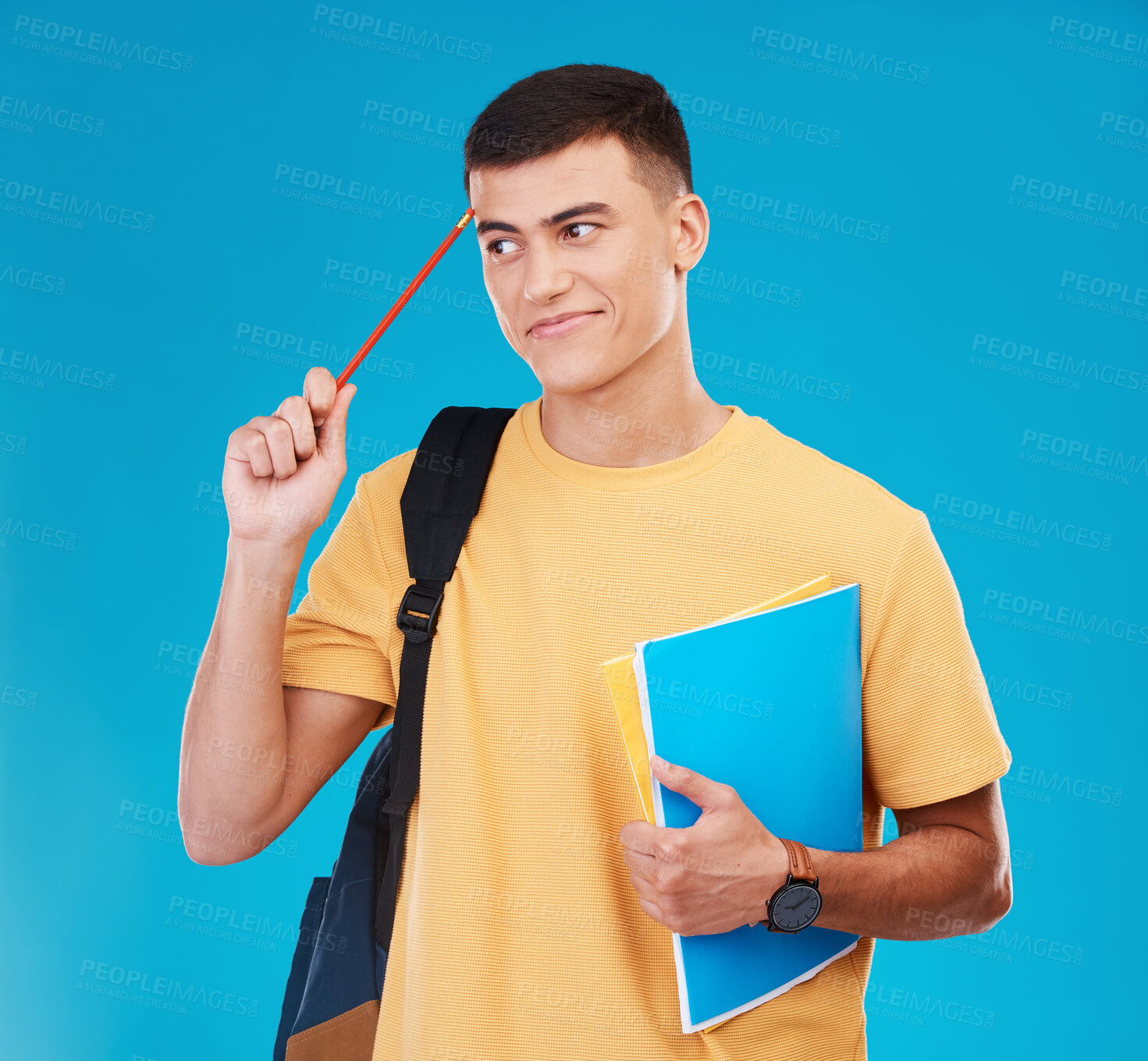 Buy stock photo Thinking, books and pencil with a man student on a blue background in studio for learning or education. University, idea and backpack with a young college student looking for study inspiration