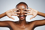 Happy, hands and portrait of black woman for skincare, beauty reveal and excited on a studio background. Smile, young and an African person with a gesture for clean facial skin or a dermatology glow