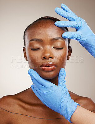 Buy stock photo Portrait, gloves and plastic surgery on face of a black woman in studio on a gray background for cosmetic change. Patient, skincare transformation and a young model getting ready for facial treatment