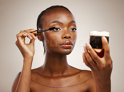 Buy stock photo Black woman, mascara with brush and mirror for beauty, makeup and shine isolated on brown background. Eyelash extension, wand and skin glow with cosmetology, transformation and wellness in studio