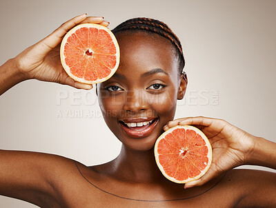 Buy stock photo Woman, grapefruit and portrait of beauty in studio for vitamin c, vegan cosmetics and glow on brown background. Face, happy african model and citrus nutrition for healthy benefits of natural skincare
