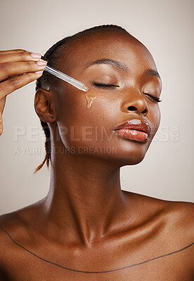 Buy stock photo Woman, beauty and oil on face in studio for aesthetic skincare, dermatology and glow on brown background. African model, facial cosmetics and dropper of hyaluronic acid, liquid and serum for shine 