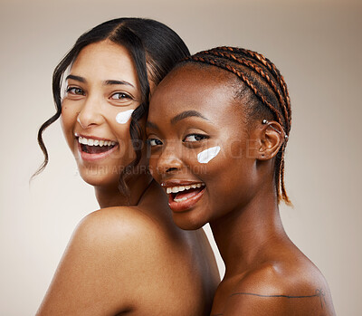 Buy stock photo Women, skincare and friends with moisturizer, diversity and cosmetics for healthy skin or facial. Portrait, wellness or glow for dermatology, natural beauty or sunscreen on face on beige background