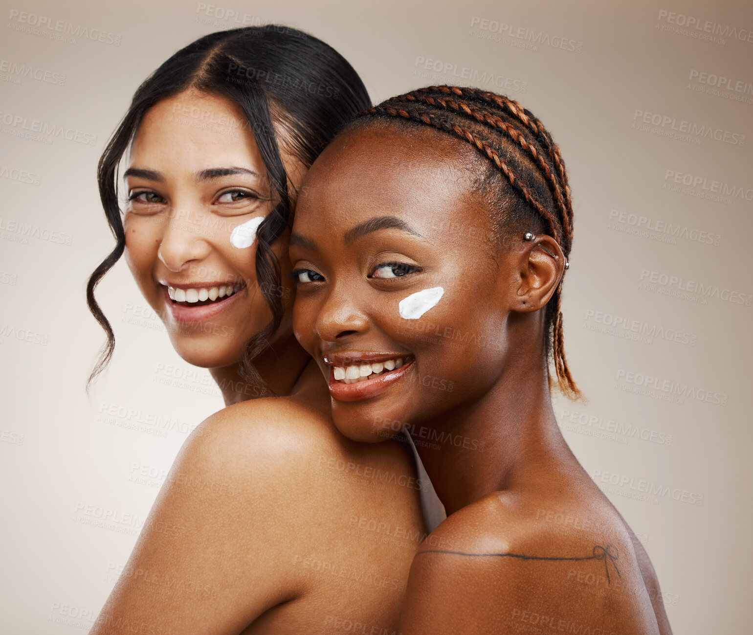 Buy stock photo Women, cream on face and beauty with diversity, friends and inclusive skincare on studio background. Dermatology, natural cosmetics and happiness in portrait, wellness and skin glow with moisturizer