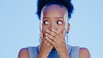 Black woman, hands covering mouth with shock or surprise, drama or secret news with gossip isolated on blue background. Wow reaction for information, expression with alarm and alert in studio 