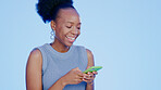 Phone, smile and black woman in a studio networking on social media, mobile app or the internet. Technology, happy and young African female model scroll on website with cellphone by blue background.