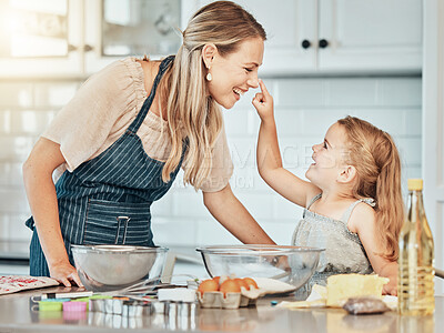 Buy stock photo Happy mother in kitchen, bake together with child and flour, playing and learning with woman. Love, mom and girl kid with help baking cookies in home with care, support and teaching at playful lunch.