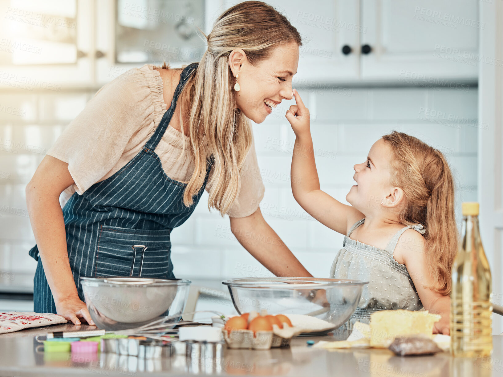 Buy stock photo Happy mother in kitchen, bake together with child and flour, playing and learning with woman. Love, mom and girl kid with help baking cookies in home with care, support and teaching at playful lunch.