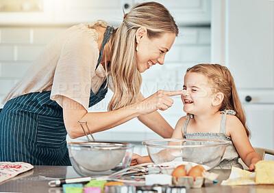 Buy stock photo Playful mother in kitchen, baking with kid and cooking fun, learning and nutrition with happy woman. Cookies, mom and girl children helping bake breakfast together in home with care, support and love