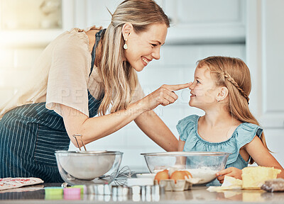 Buy stock photo Mother and daughter, baking and smile for play in kitchen and love by bonding. Happy family, fresh ingredients and fun in learning, cake and dessert or pastry for breakfast, snacks and food at home