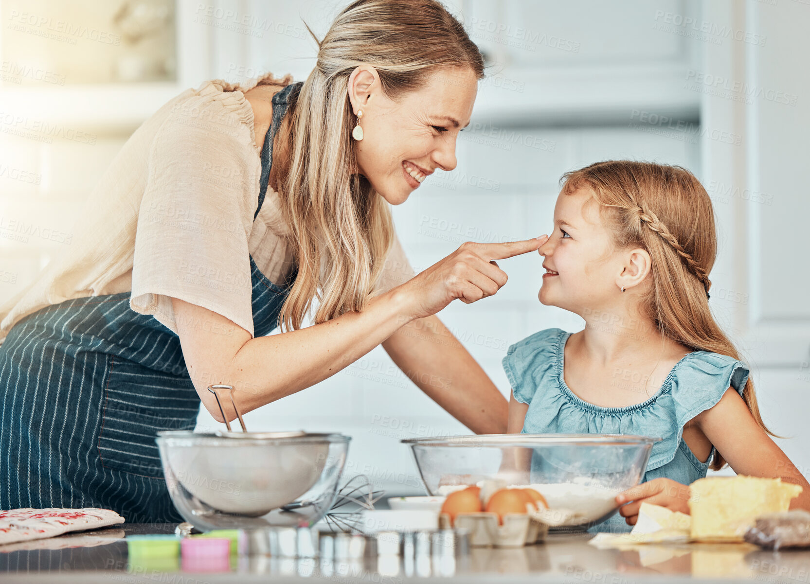 Buy stock photo Mother and daughter, baking and smile for play in kitchen and love by bonding. Happy family, fresh ingredients and fun in learning, cake and dessert or pastry for breakfast, snacks and food at home